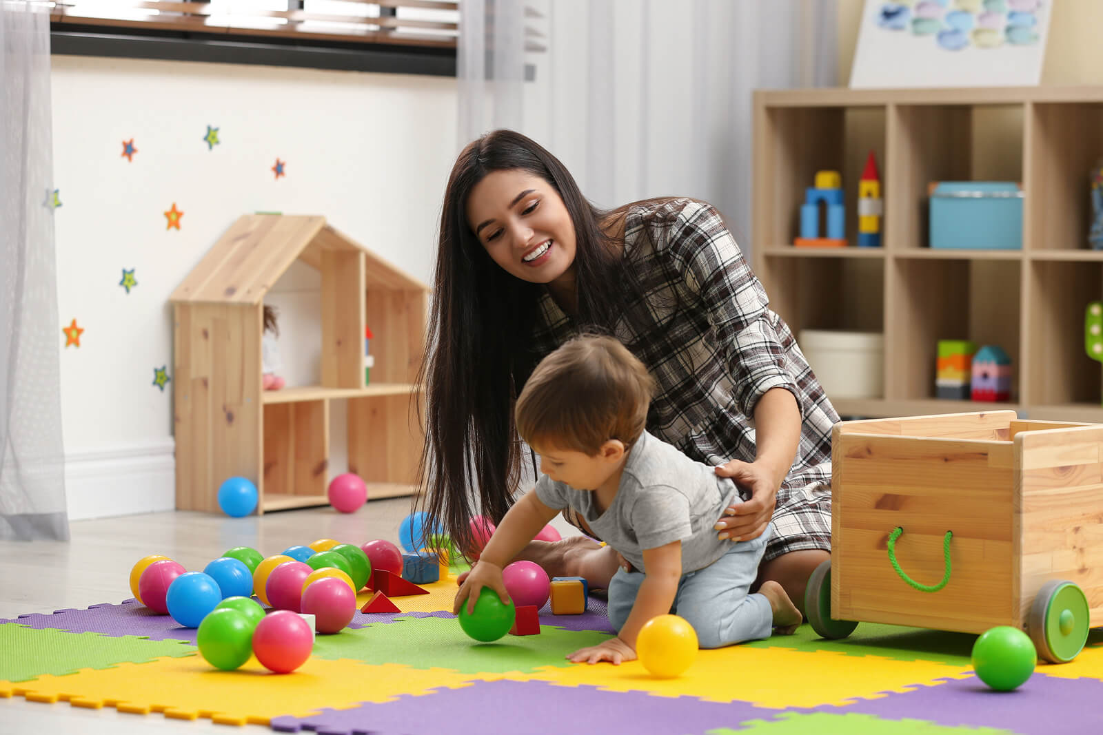 A childcare professional playing with a young child